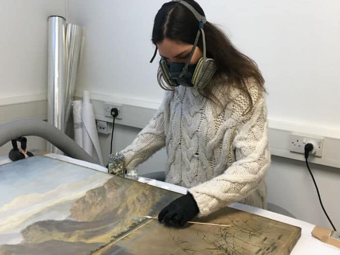 An oil painting being cleaned by the Fine art restoration company