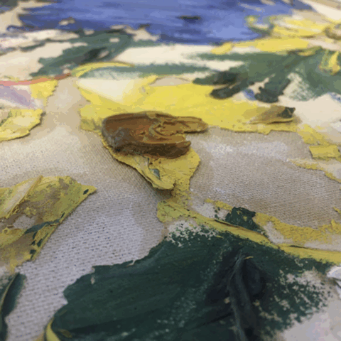 Close up of flaking paint on poorly prepared canvas
