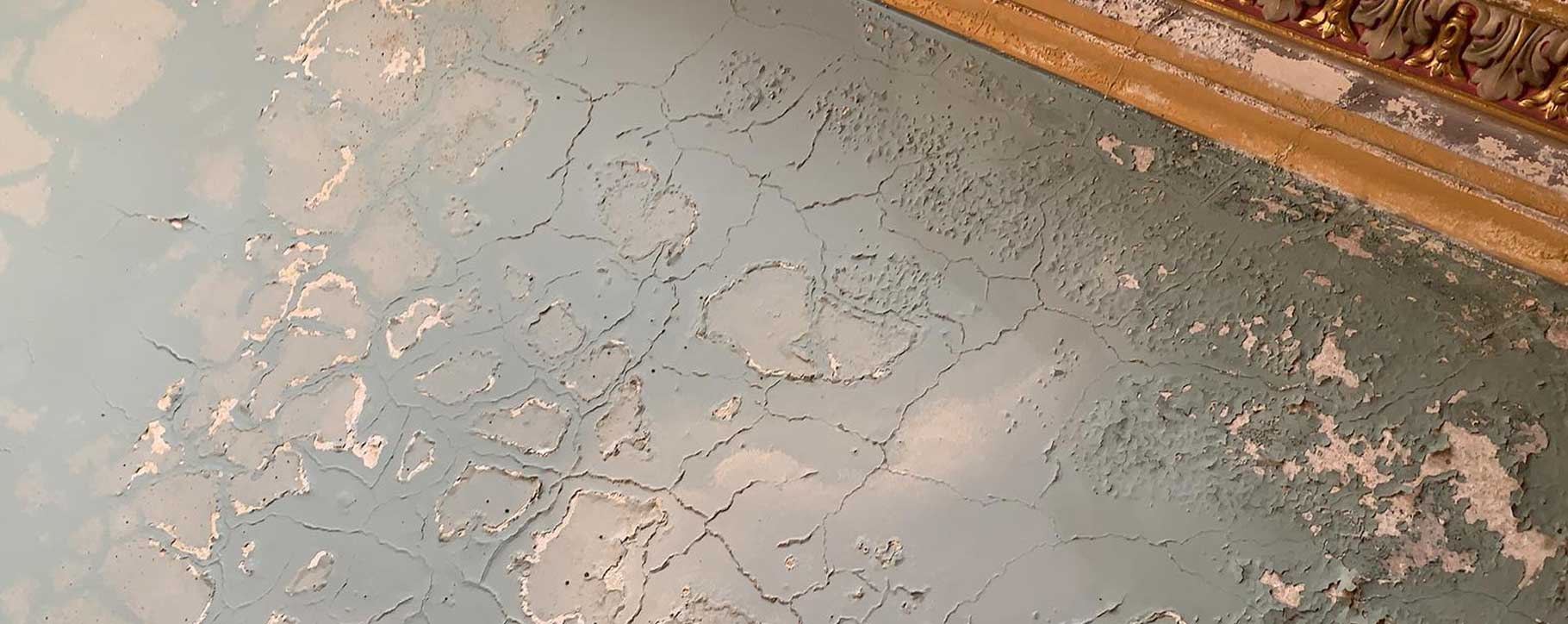 cracked and flaking paint on westonbirt school ceiling